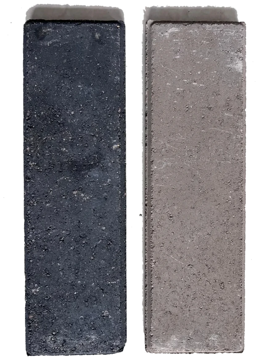 Two custom-color thin brick samples in deep charcoal and warm gray finishes