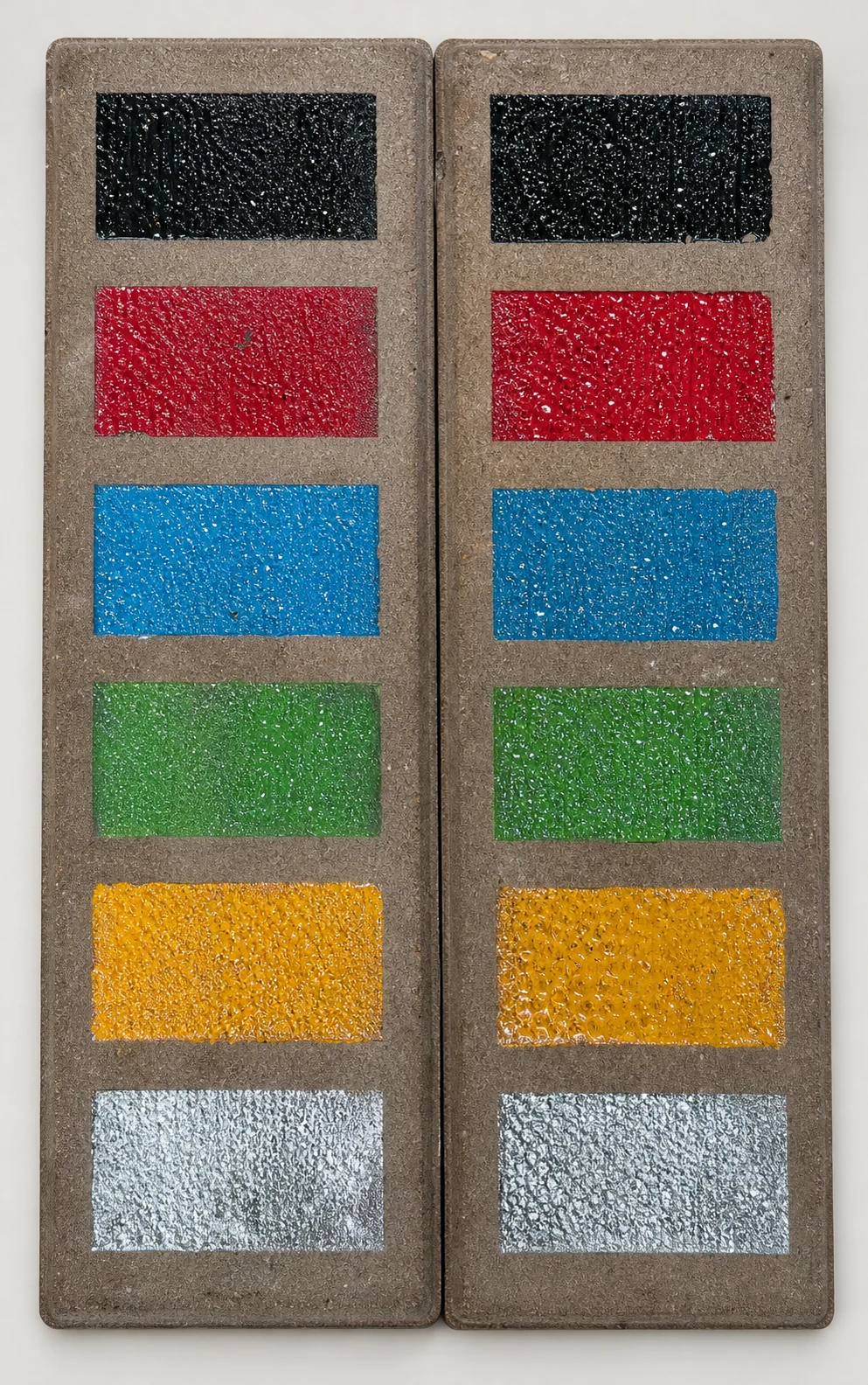 Black, red, blue, green, yellow and silver laser-pigmented color samples integrated into textured thin brick